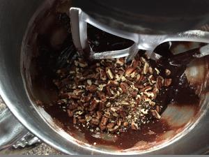 Adding pecans to the brownie batter
